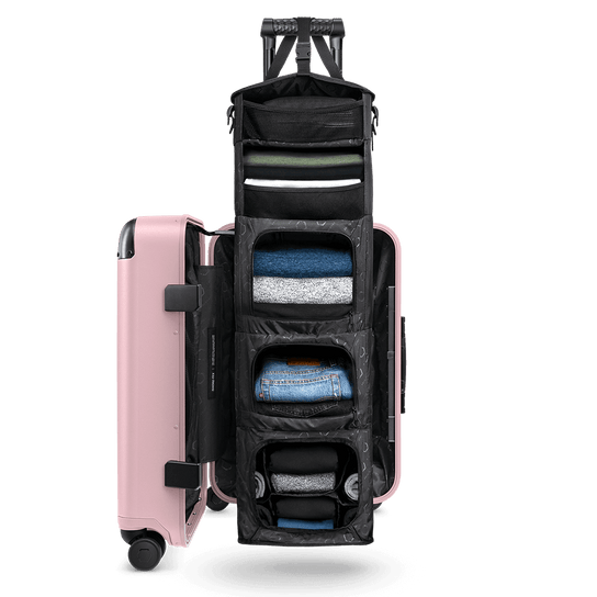 Pink Carry-On Closet Original medium luggage — organized open suitcase with built-in shelving system